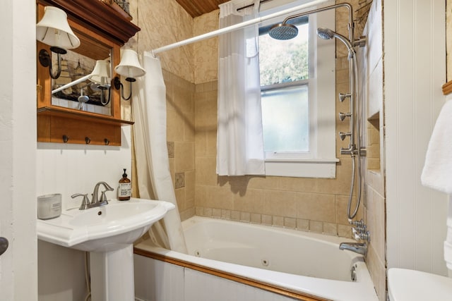 bathroom with shower / tub combo with curtain and toilet