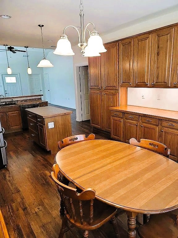 kitchen featuring pendant lighting, a notable chandelier, dark hardwood / wood-style floors, and a kitchen island