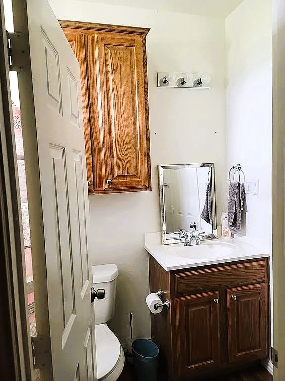 bathroom featuring vanity and toilet