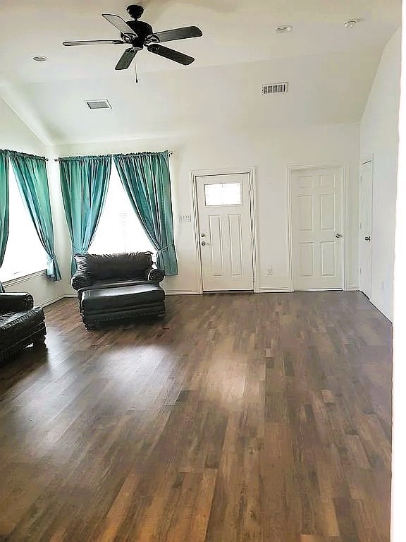 foyer featuring dark wood-type flooring, ceiling fan, and vaulted ceiling