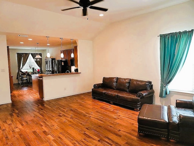 living room with vaulted ceiling, ceiling fan, and dark hardwood / wood-style flooring