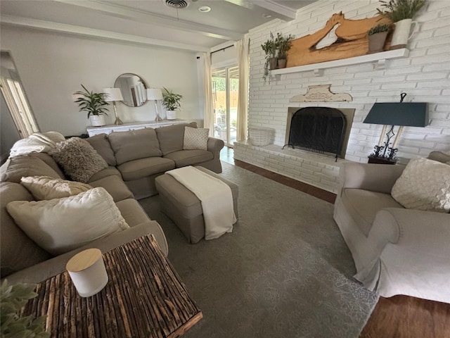 carpeted living room featuring beamed ceiling and a fireplace