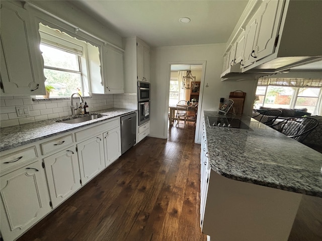 kitchen featuring plenty of natural light, dark hardwood / wood-style flooring, sink, dishwasher, and black electric cooktop