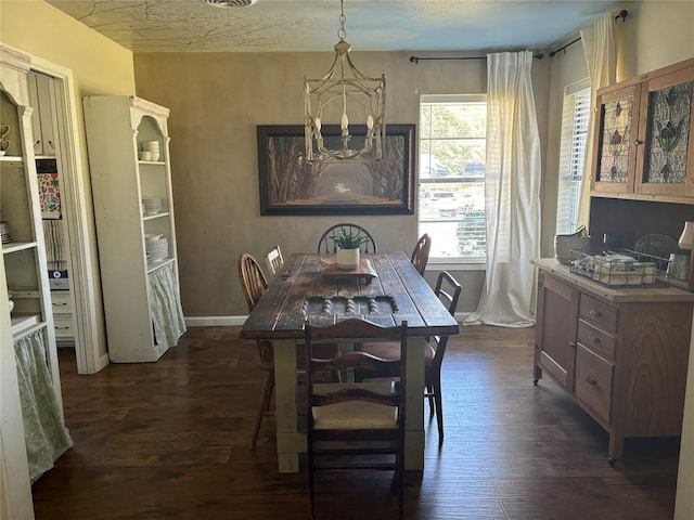 dining area featuring an inviting chandelier and dark hardwood / wood-style floors