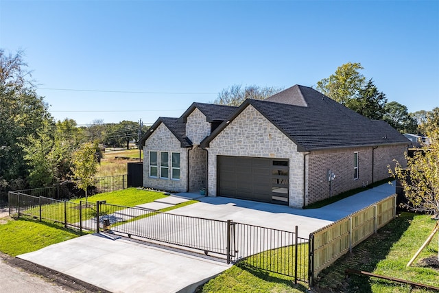 view of front of home with a garage and a front lawn