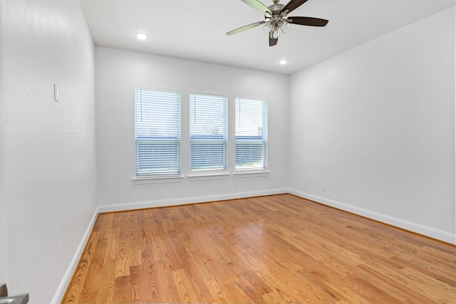 empty room featuring ceiling fan and light hardwood / wood-style flooring