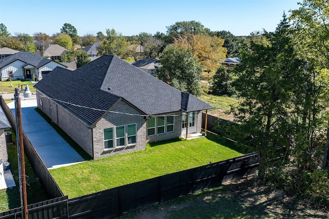 back of property with a lawn