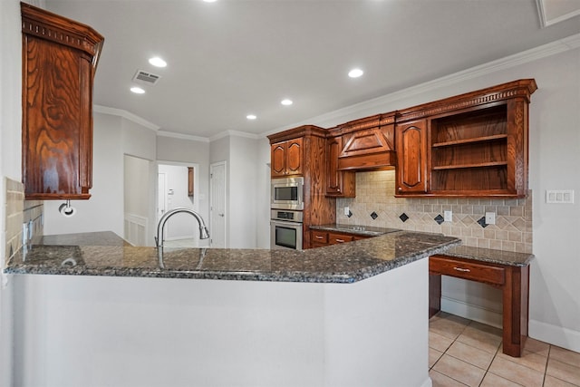 kitchen with dark stone counters, kitchen peninsula, decorative backsplash, and stainless steel appliances