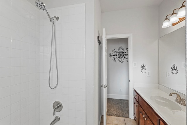 bathroom with tiled shower / bath, vanity, and tile patterned floors