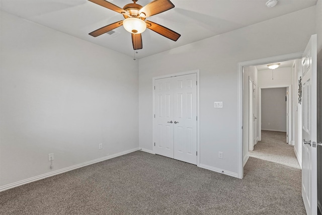 unfurnished bedroom featuring light carpet, ceiling fan, and a closet