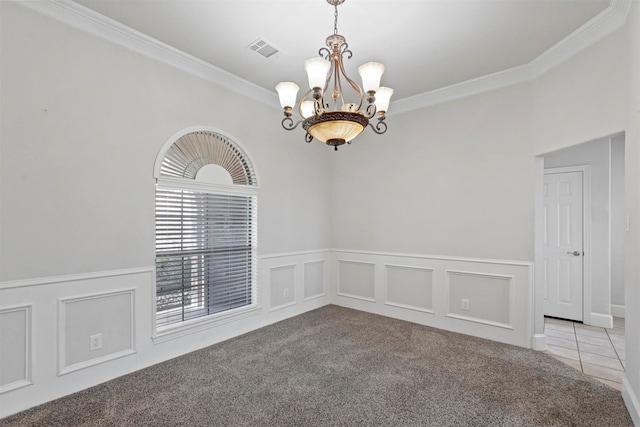 spare room with ornamental molding, light carpet, and a chandelier