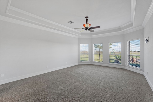 carpeted spare room with crown molding, ceiling fan, and a raised ceiling