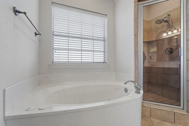 bathroom with tile patterned flooring and separate shower and tub