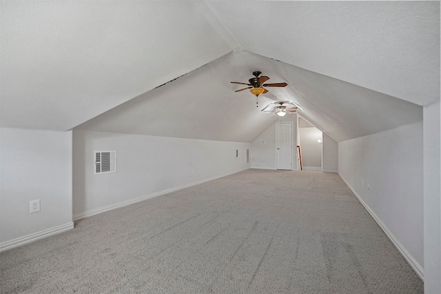 bonus room featuring ceiling fan, light colored carpet, and lofted ceiling