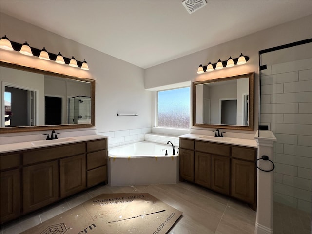 bathroom with tile patterned flooring, vanity, and shower with separate bathtub