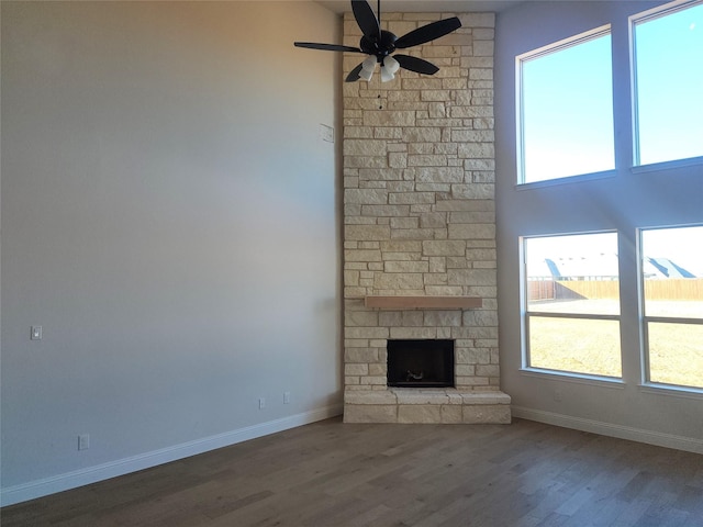 unfurnished living room with hardwood / wood-style flooring, ceiling fan, and a fireplace