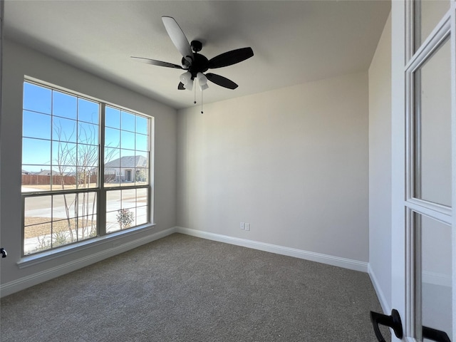 carpeted spare room with plenty of natural light and ceiling fan