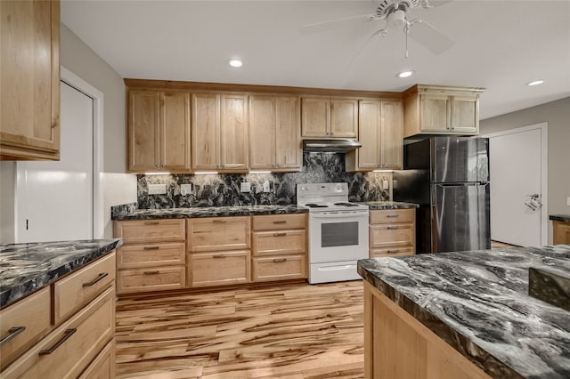 kitchen with stainless steel refrigerator, white electric stove, light brown cabinetry, dark stone countertops, and light hardwood / wood-style flooring