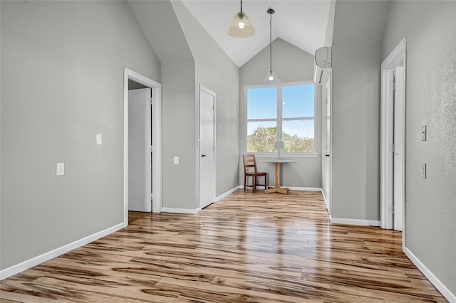 interior space featuring light wood-type flooring and lofted ceiling