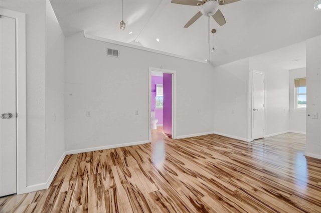 empty room featuring light wood-type flooring, ceiling fan, and vaulted ceiling