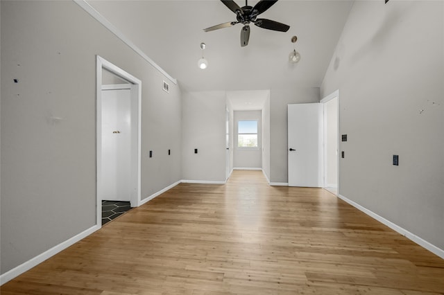 spare room with ceiling fan, light wood-type flooring, and lofted ceiling