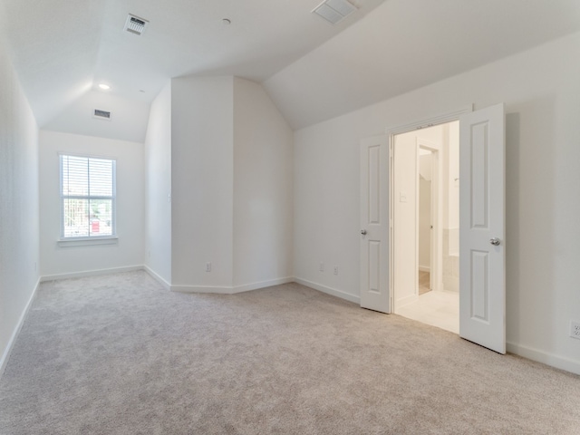 bonus room featuring lofted ceiling and light carpet