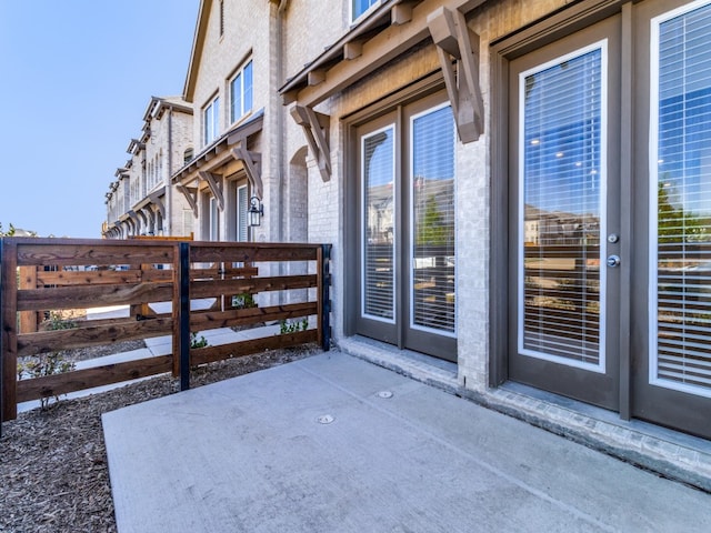 view of exterior entry featuring a patio area