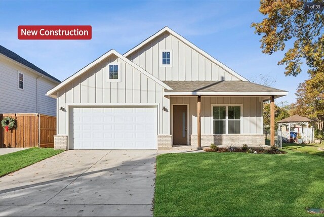 view of front of property with a garage and a front lawn