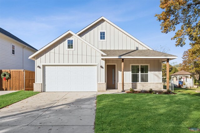 view of front of property with a front yard and a garage