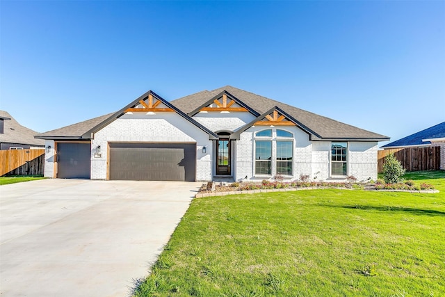 view of front facade with a garage and a front lawn