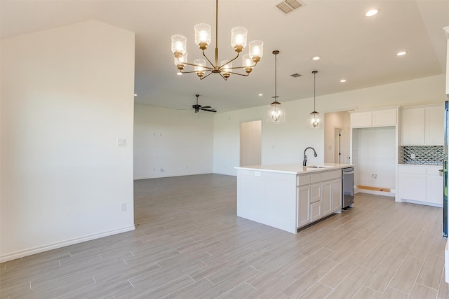 kitchen featuring a center island with sink, white cabinetry, hanging light fixtures, light hardwood / wood-style floors, and ceiling fan