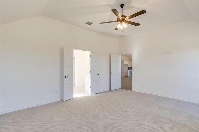 carpeted spare room featuring lofted ceiling and ceiling fan