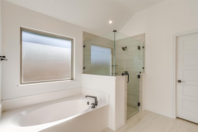 bathroom featuring shower with separate bathtub and vaulted ceiling