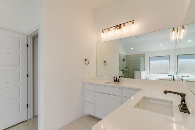 bathroom featuring walk in shower and vanity