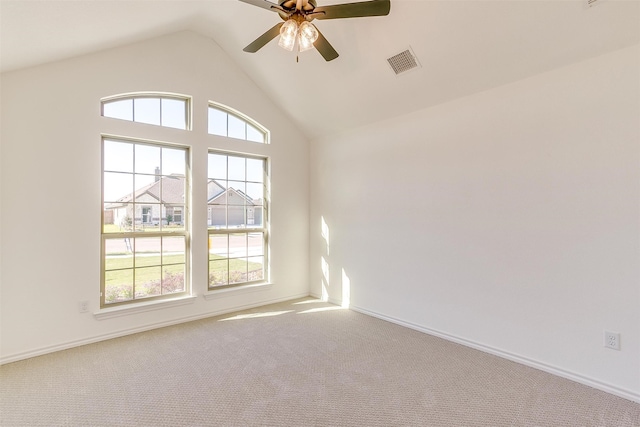 carpeted empty room with high vaulted ceiling, plenty of natural light, and ceiling fan