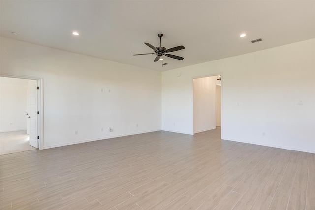 empty room featuring light wood-type flooring and ceiling fan