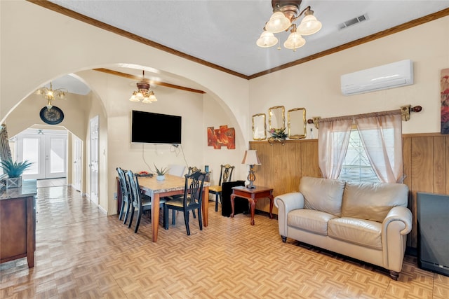 dining area with light parquet flooring, ornamental molding, ceiling fan, and a wall mounted air conditioner