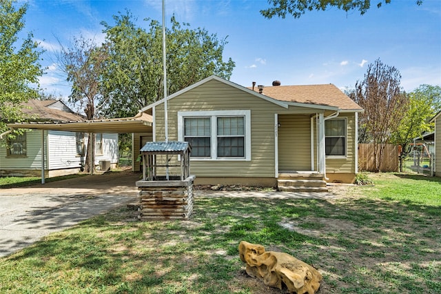 bungalow-style home with a front lawn and a carport