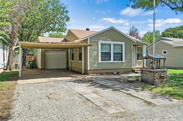 bungalow featuring a garage and central AC