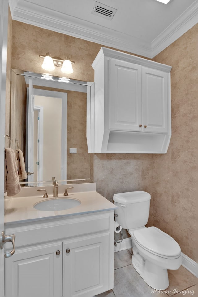 bathroom featuring toilet, vanity, tile patterned floors, and crown molding