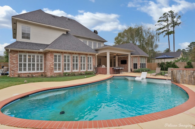 view of pool featuring ceiling fan, pool water feature, and a patio area