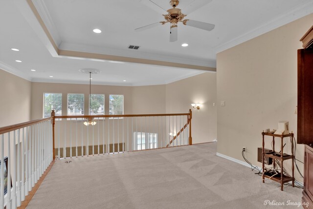 spare room featuring light colored carpet, ceiling fan, and crown molding