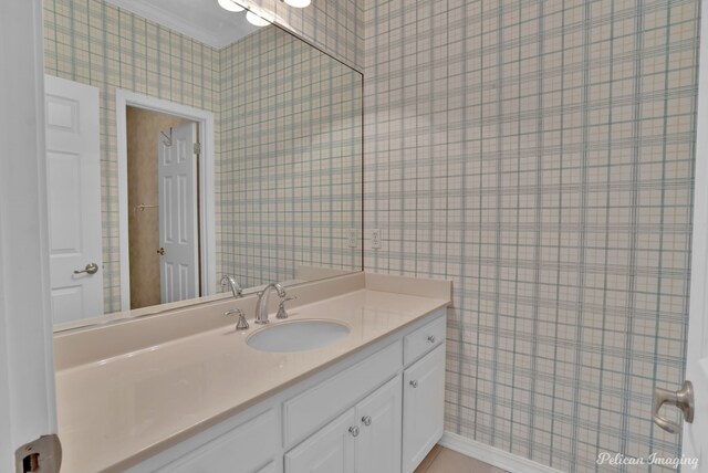 unfurnished bedroom with ornamental molding, light colored carpet, ceiling fan, and connected bathroom