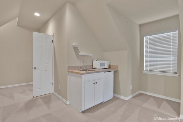 bathroom featuring vanity, tile patterned flooring, toilet, and lofted ceiling