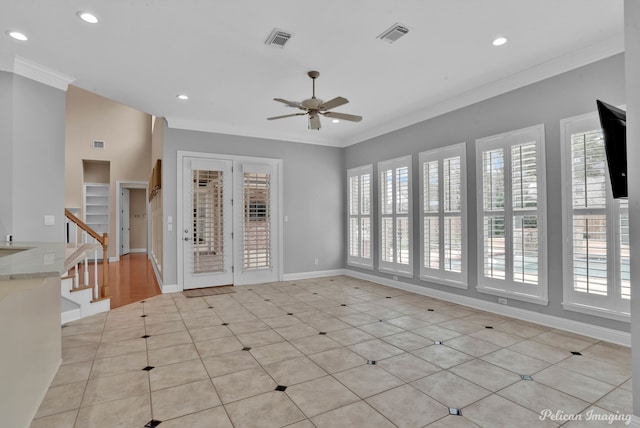 empty room featuring ceiling fan, light tile patterned floors, and ornamental molding