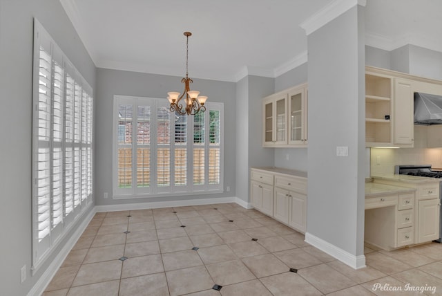 unfurnished dining area with an inviting chandelier, light tile patterned flooring, and crown molding