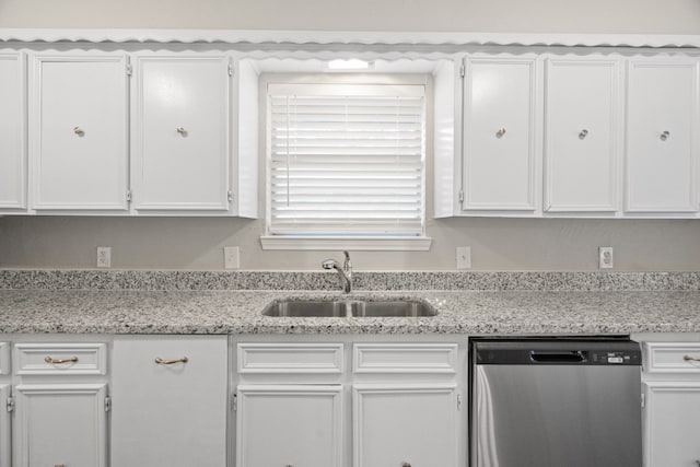 kitchen with white cabinetry, stainless steel dishwasher, sink, and light stone countertops