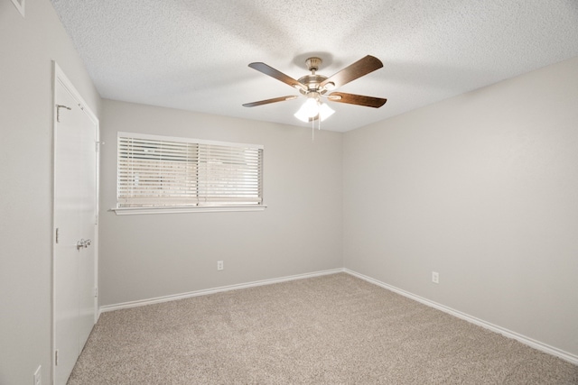 carpeted empty room with a textured ceiling and ceiling fan