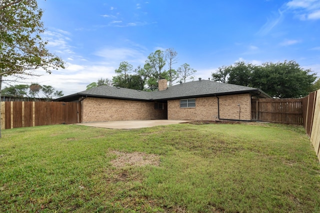 rear view of house with a patio area and a yard