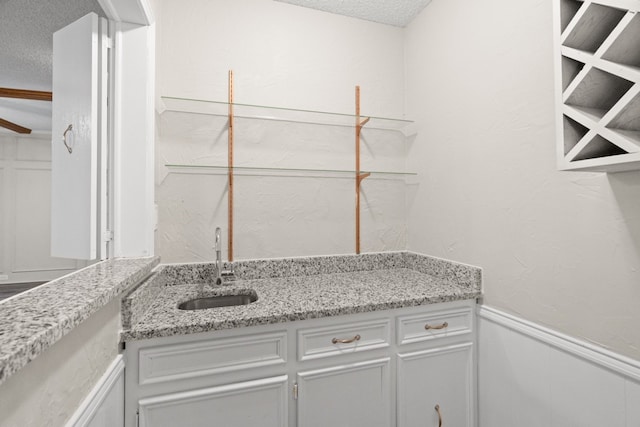 interior space featuring sink and a textured ceiling